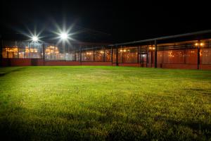 a building with two lights in a field at night at Hotel Brök San Juan del Río in San Juan del Río