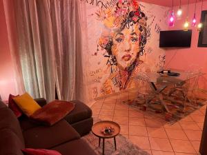 a living room with a couch and a table at The Loft E&E Cinecittà in Empoli