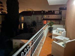 a balcony with chairs and a railing on a building at The Loft E&E Cinecittà in Empoli