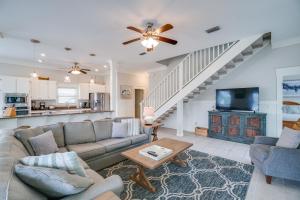 a living room with a couch and a tv at 30A Beach House - Walking on Sunshine in Inlet Beach