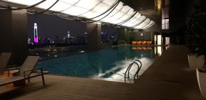 a swimming pool with a view of the city at night at MCity Jalan Ampang KLCC in Kuala Lumpur
