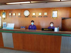 two people wearing face masks standing at a bar at Mike Beach Resort in Pattaya +49 photos