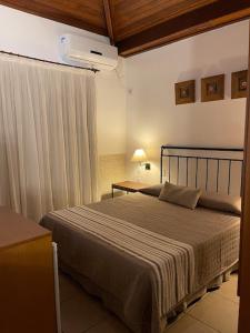 מיטה או מיטות בחדר ב-Hotel Vila Serrana