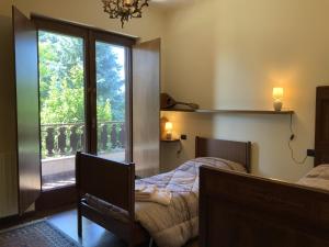1 dormitorio con cama y ventana en Villa Milano e Malpensa vicino MXP e FIERE, en Vanzaghello