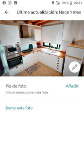 a kitchen with white cabinets and a stove top oven at Apartamento los limoneros in Estepona