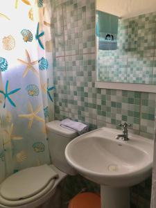 a bathroom with a toilet and a sink at Suíte externa com entrada independente in São Sebastião