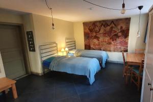 a bedroom with two beds and a painting on the wall at Villa Haniel Apartment Frieda in Dresden