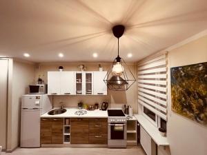 a small kitchen with a sink and a stove at Apartment128 in Valmiera