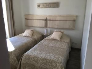 two beds sitting next to each other in a room at Appart République in Narbonne