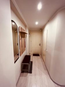 a hallway with a mirror and a dressing room at Apartment128 in Valmiera