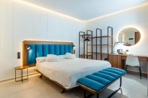 a bedroom with a large bed with a blue headboard at Flatguest RoomTiques Private Rooms in Las Palmas de Gran Canaria