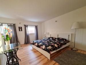 a bedroom with a bed and a table and a window at Sweet House and Apartment in Rovinj