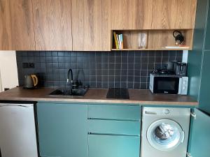 Kuchyň nebo kuchyňský kout v ubytování Alpic Redco New Gudauri Apartment 305