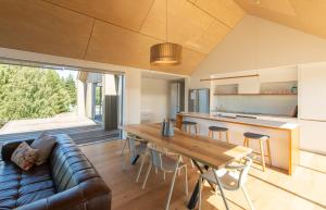 a kitchen and living room with a couch and a table at Villa Kaki in Lake Tekapo