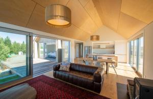 a living room with a couch and a table at Villa Kaki in Lake Tekapo
