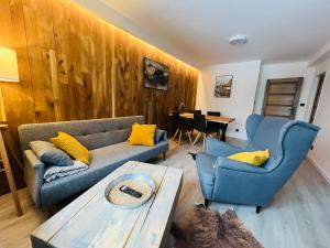a living room with a couch and two chairs and a table at Apartmány Panorama Harrachov in Harrachov