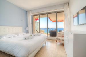 - une chambre avec un lit et une vue sur l'océan dans l'établissement IMMOGROOM- 2 bedrooms -Panoramic Sea view - Huge Terrace - Beach, à Cannes