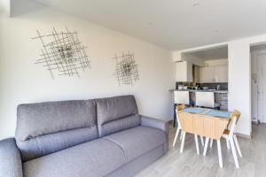 - un salon avec un canapé et une table dans l'établissement IMMOGROOM - Renovated apartment - Terrace - AC - Wifi, à Cannes