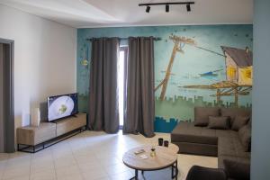 a living room with a couch and a tv at Petrino Suites Mesolonghi in Missolonghi