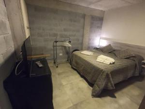 - une chambre avec un lit et des serviettes dans l'établissement Trastolillo Villa Gesell, à Villa Gesell