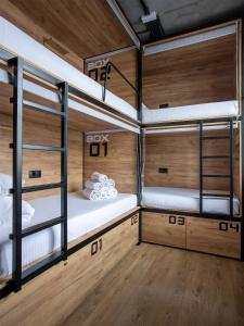 two bunk beds in a room with wooden floors at VIA Hostel in Kazan