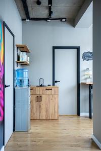 a kitchen with a refrigerator and a wooden cabinet at VIA Hostel in Kazan