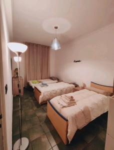 a hotel room with two beds and a lamp at La pepita del Ling8 in Turin