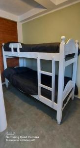 Ένα ή περισσότερα κρεβάτια σε δωμάτιο στο Merlo 1