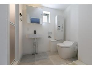a white bathroom with a toilet and a sink at AOCA Kaminoge - Vacation STAY 11980 in Tokyo