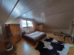 a room with a bed and a cow print rug at Wellness Srub Jaroměř in Kaplice