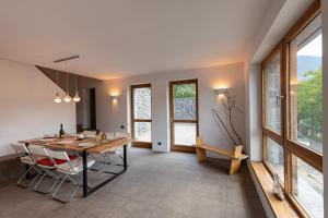 a dining room with a table and some windows at Anastasia House in Nimfasía