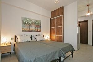 a bedroom with a bed and a painting on the wall at Villa Angela in Vourvourou