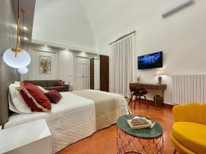 a bedroom with a bed and a desk in a room at Palazzo Bianchi - Trani in Trani