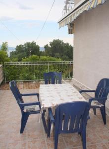 einen Tisch und vier Stühle auf einer Terrasse in der Unterkunft Apartments Ivan in Crikvenica
