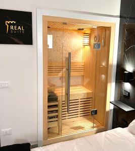 a glass door in a room with a bed at Real suite spa in Palermo