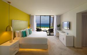 a bedroom with a bed and a view of the ocean at Paradisus Cancun All Inclusive in Cancún