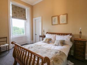 a bedroom with a bed with two teddy bears on it at Woodside House in Arbroath