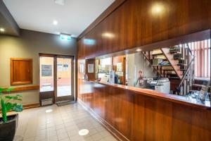 a lobby of a restaurant with a counter and aacistacistacistacist at Meadow Inn Hotel-Motel in Melbourne
