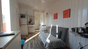 a small kitchen with a couch in a room at B&B du Cerisier, diner sur demande in Noyers