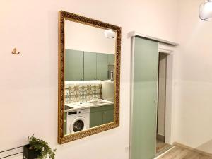 uno specchio a parete con lavatrice di PAU18 Apartments a Budapest
