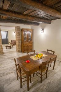 a dining room with a wooden table with fruit on it at La Dimora di Giano in Dragoni