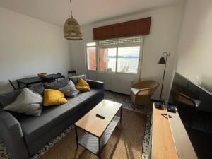 a living room with a couch and a table at Oktheway Perbes Beach Vintage in Boebre