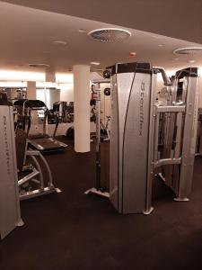 a gym with treadmills and machines in a room at Studio Diamondlux Vrnjačka Banja in Vrnjačka Banja