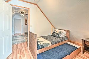a small bedroom with a bed and a table at Near Trails, Lakes and Golf Pinetop Home with Deck in Pinetop-Lakeside
