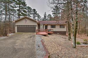 a house with a garage and a driveway at 15 Mi to Hot Springs Natl Park Home with Fire Pit! in Hot Springs Village