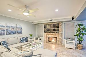 a living room with a couch and a fireplace at Pet-Friendly La Quinta Gem with Pool and Yard Games in La Quinta