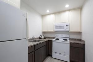 a kitchen with white appliances and a white refrigerator at Super 8 by Wyndham Eureka in Eureka