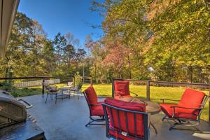 a patio with chairs and tables and a grill at Mod Stable House on 10 Acres, Walk to Lake! in Oakwood