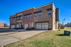 a red brick building with a garage at Edmond Oasis with Rooftop Lounge Walk to Dtwn! in Edmond