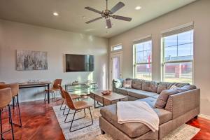 a living room with a couch and a table at Edmond Oasis with Rooftop Lounge Walk to Dtwn! in Edmond